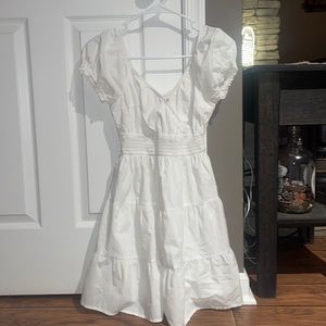 White dress, sinched in at the waist, has a little clip at the chest :)